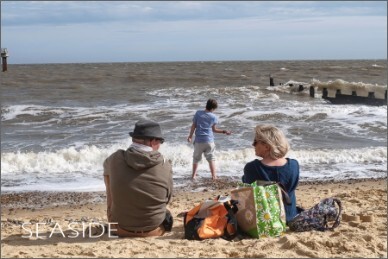 Photo of a family at the beach on a windy day.